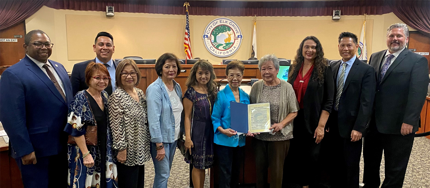 a group of people receiving a proclamation from the city council 