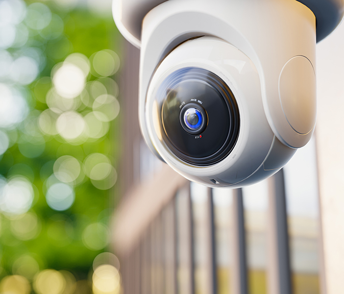 security camera with greenery in background