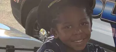 little kid on a motorcycle smiling